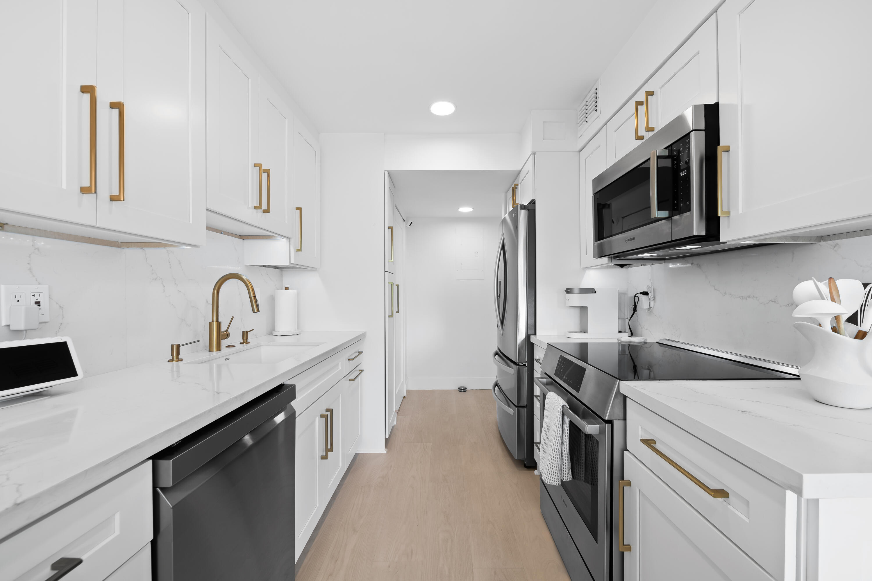 799 Jeffery Street, Unit 303 Boca Raton, FL 33487 - Photo 6 of 42 a kitchen with stainless steel appliances a sink a stove a microwave a sink and cabinets