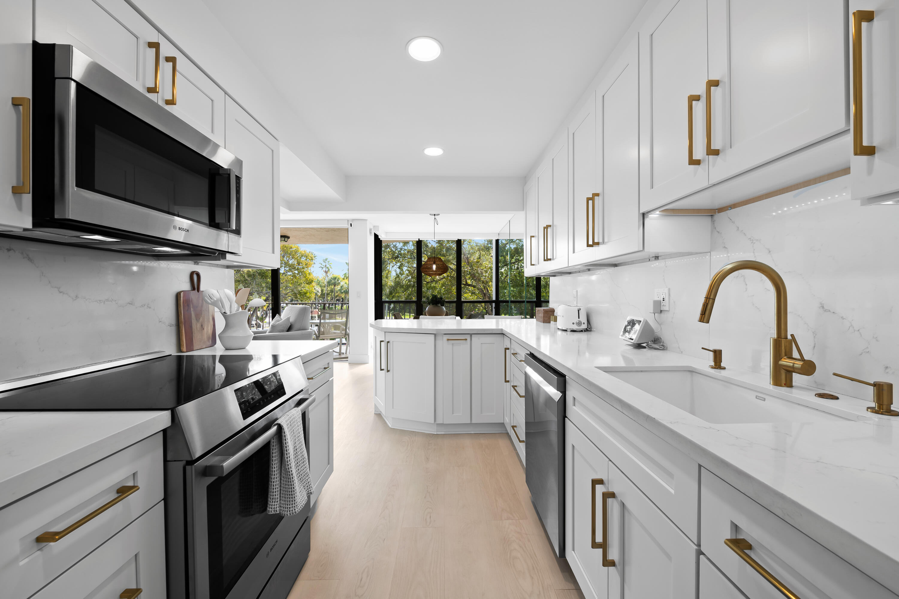 799 Jeffery Street, Unit 303 Boca Raton, FL 33487 - Photo 7 of 42 a kitchen with a sink stainless steel appliances and cabinets