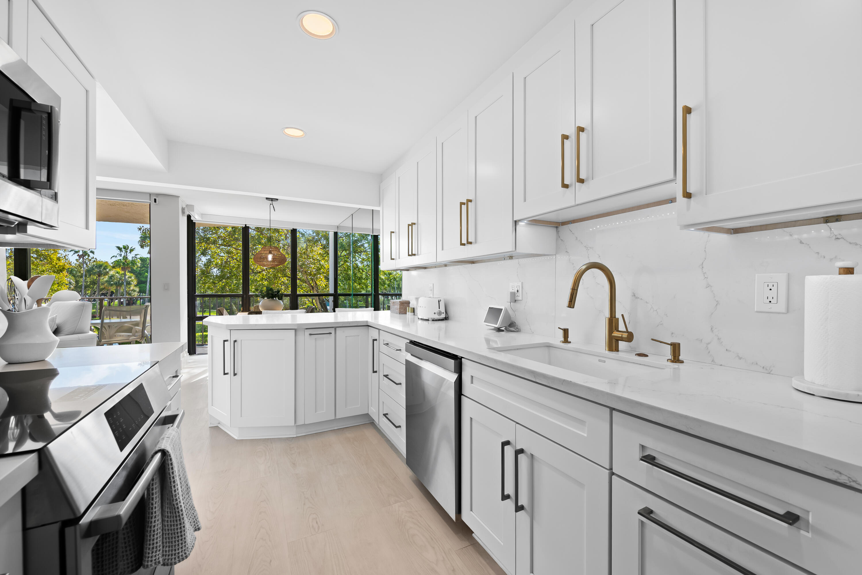 799 Jeffery Street, Unit 303 Boca Raton, FL 33487 - Photo 8 of 42 a kitchen with sink cabinets and window