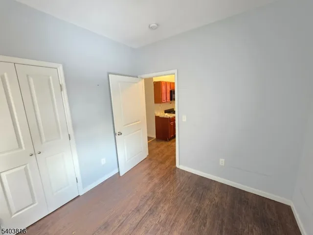 a view of a room with wooden floor and staircase