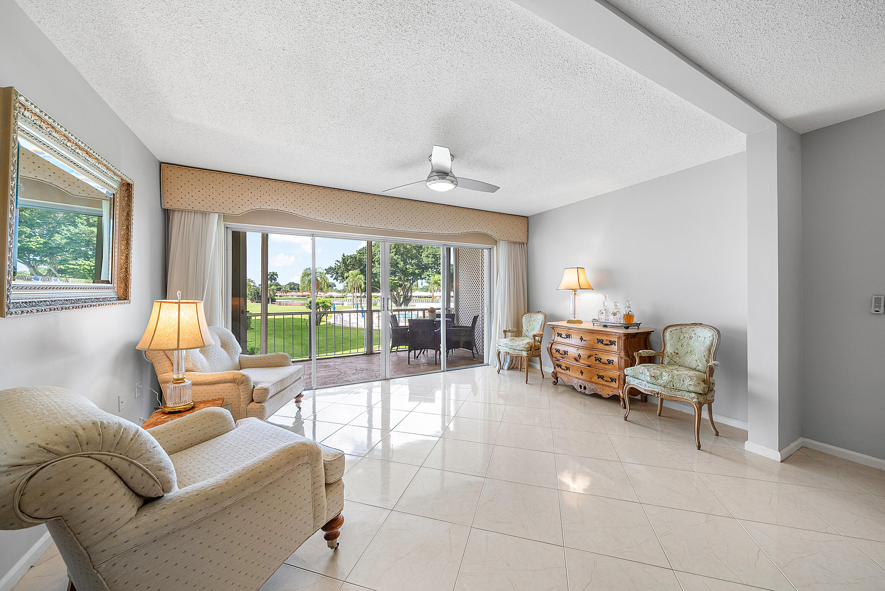 145 Atlantis Boulevard, Unit 201 Atlantis, FL 33462 - Photo 14 of 40 a view of a livingroom with furniture and floor to ceiling window