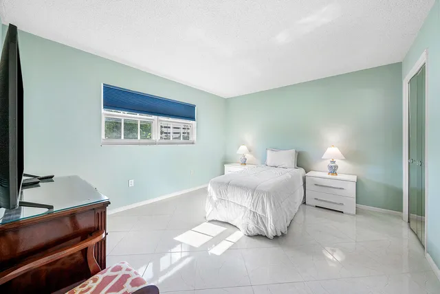 a spacious bedroom with a bed and a desk