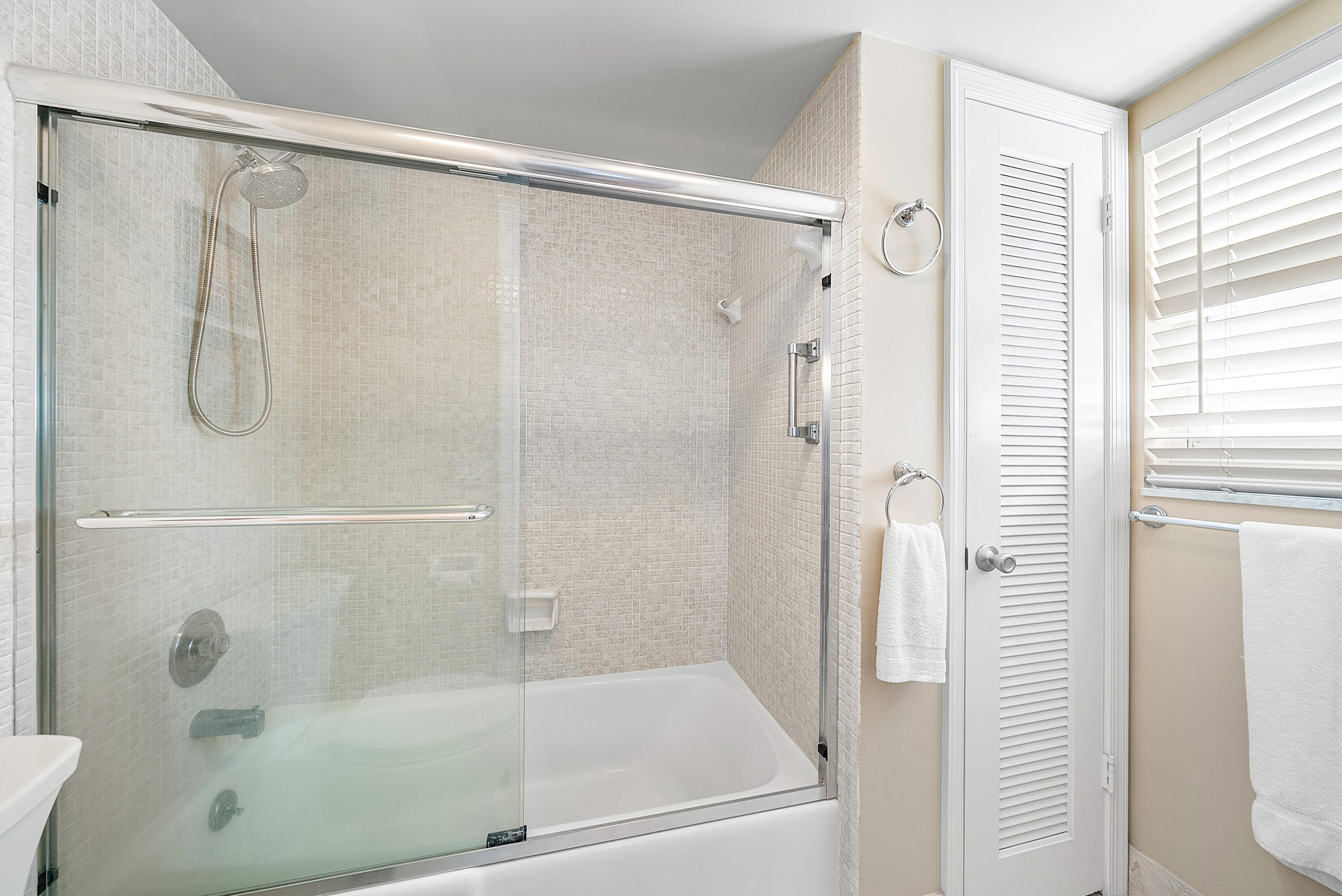 145 Atlantis Boulevard, Unit 201 Atlantis, FL 33462 - Photo 24 of 40 a bathroom with a shower and a bath tub