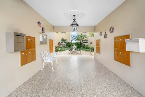 a view of a kitchen with furniture and wooden floor