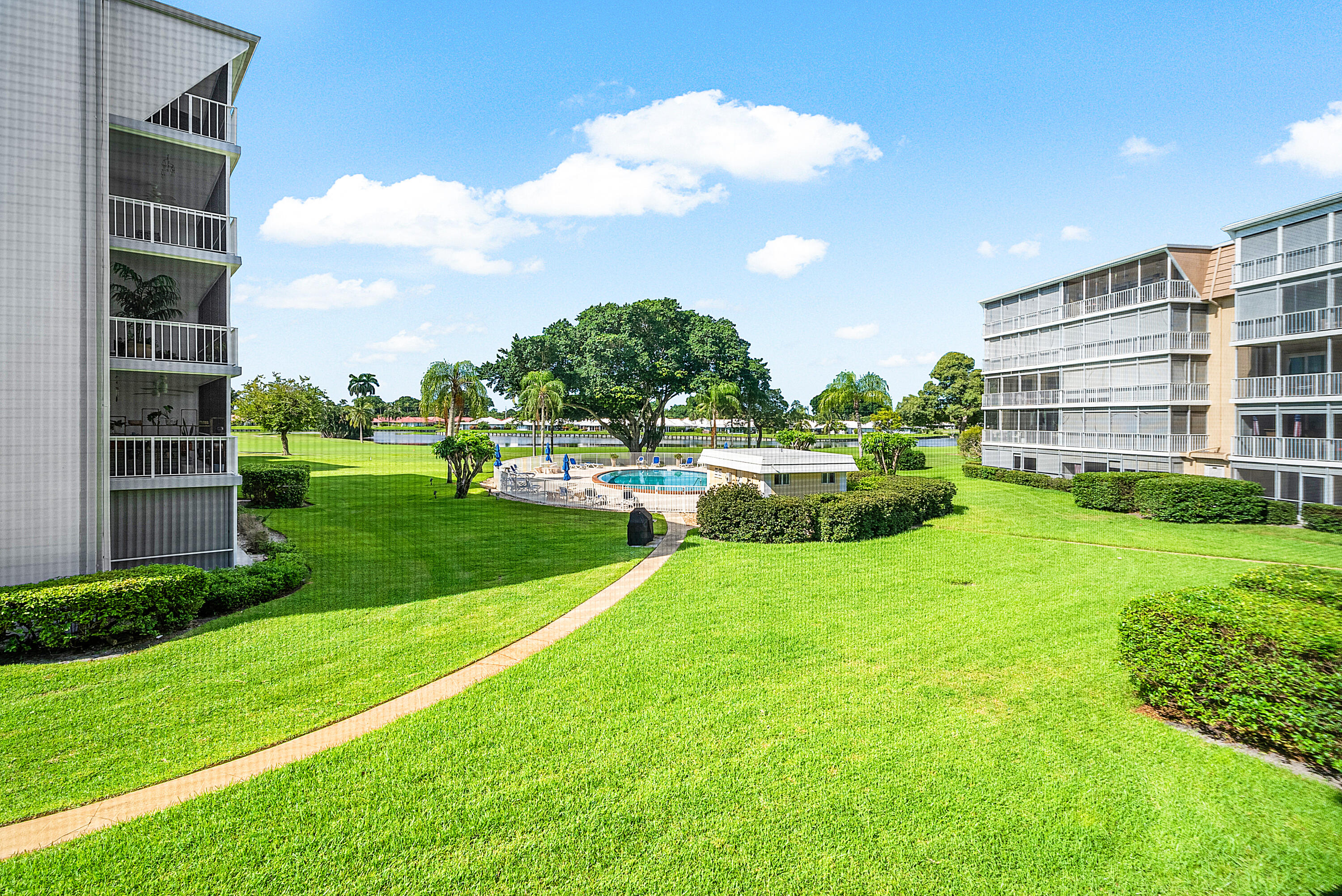 145 Atlantis Boulevard, Unit 201 Atlantis, FL 33462 - Photo 31 of 40 a view of a big room with a big yard and potted plants