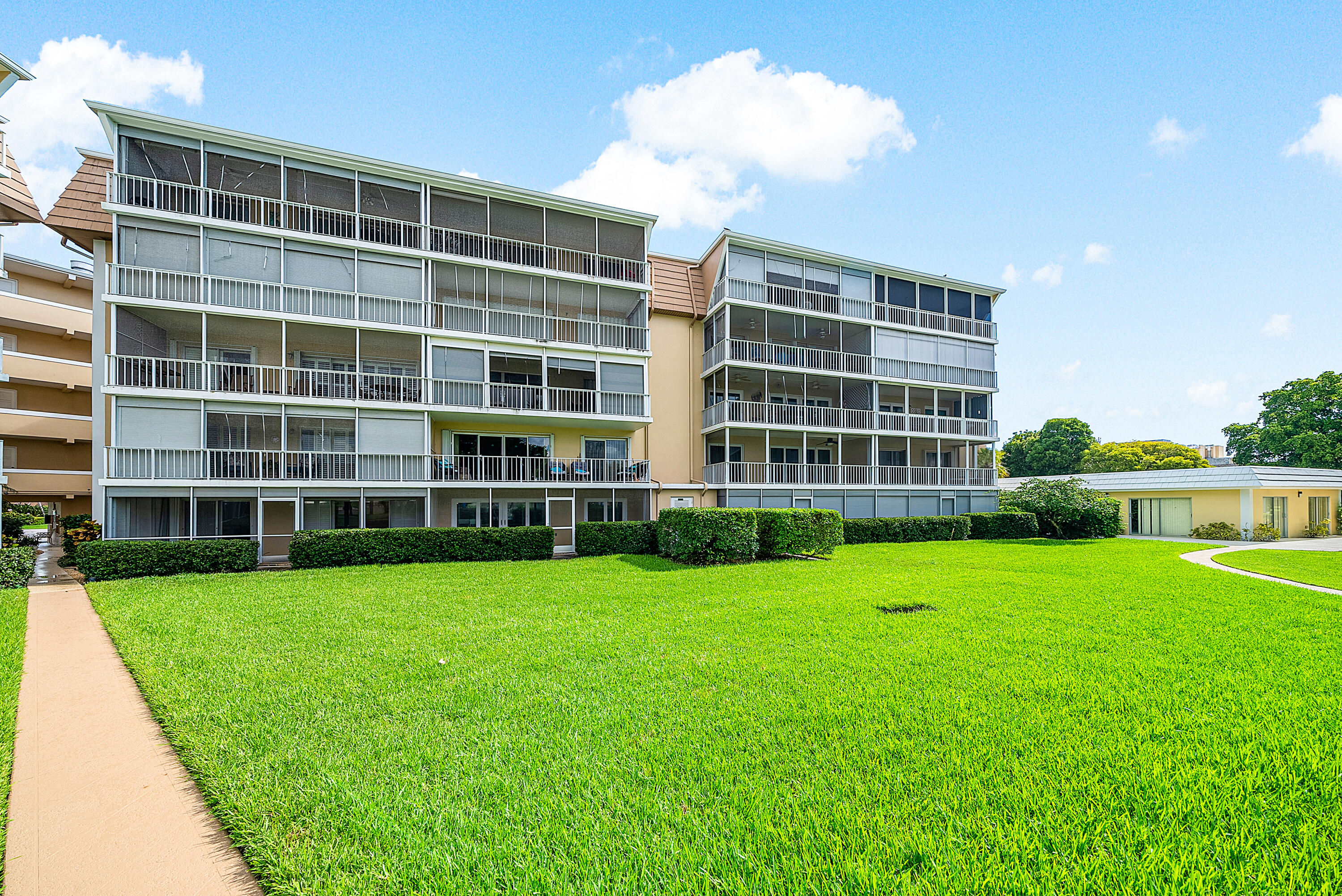 145 Atlantis Boulevard, Unit 201 Atlantis, FL 33462 - Photo 33 of 40 a view of an apartment with a garden and plants