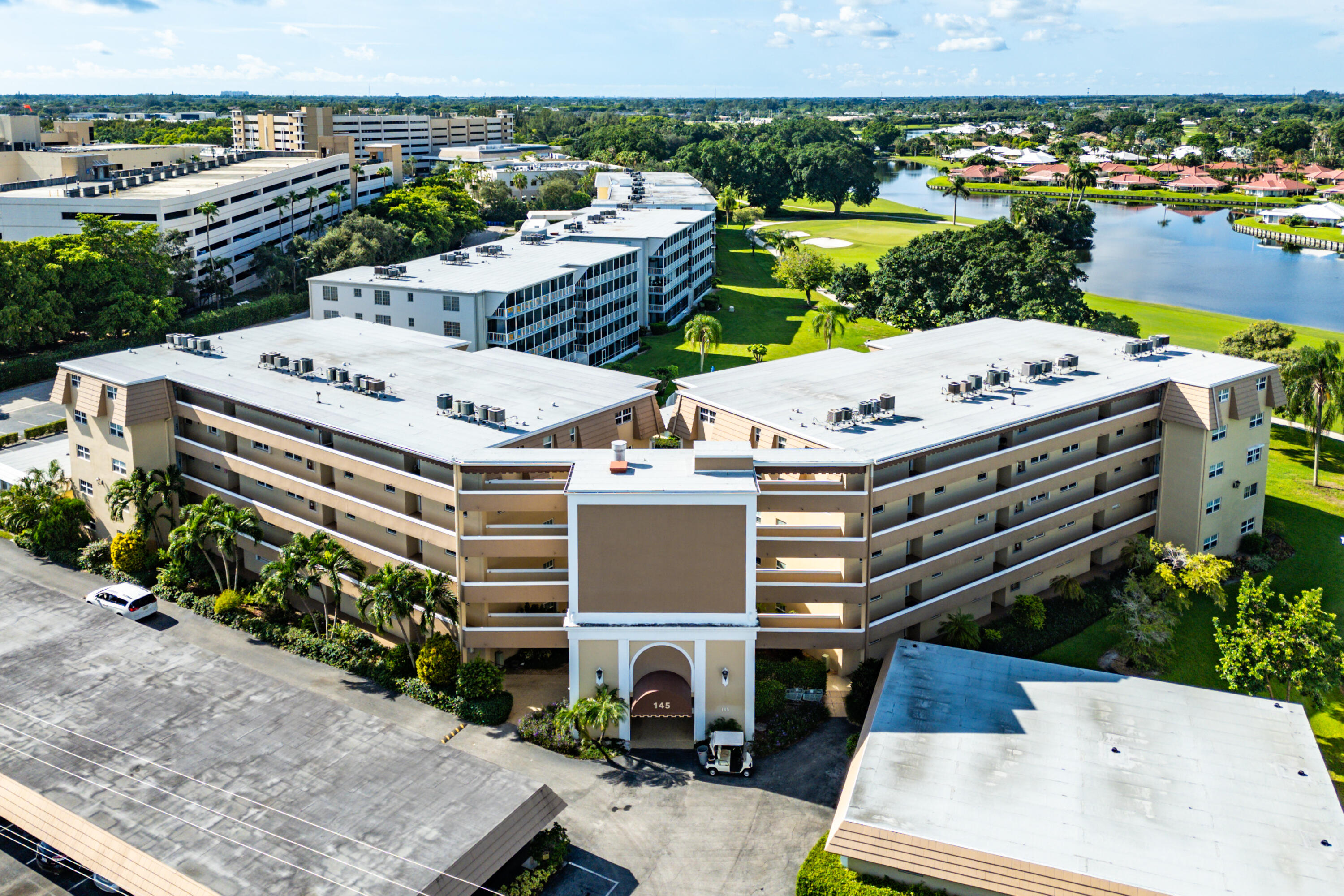145 Atlantis Boulevard, Unit 201 Atlantis, FL 33462 - Photo 36 of 40 an aerial view of a house with a yard patio and outdoor seating