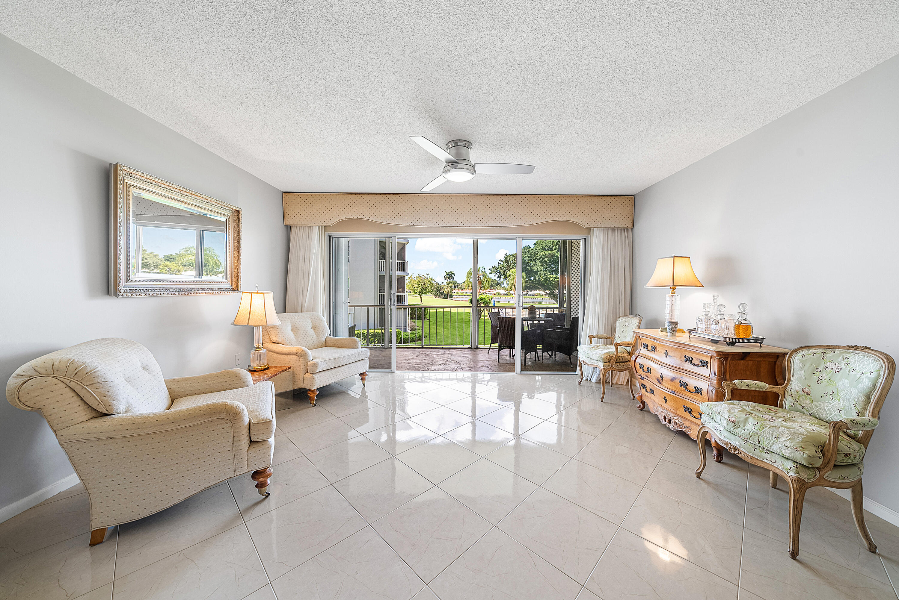 145 Atlantis Boulevard, Unit 201 Atlantis, FL 33462 - Photo 9 of 40 a living room with furniture and a large window