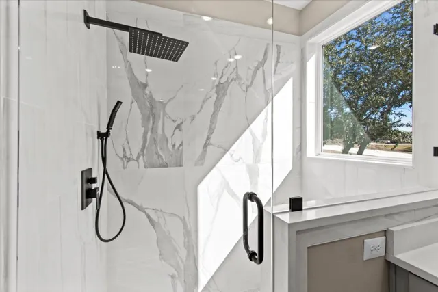 a bathroom with a shower and a window