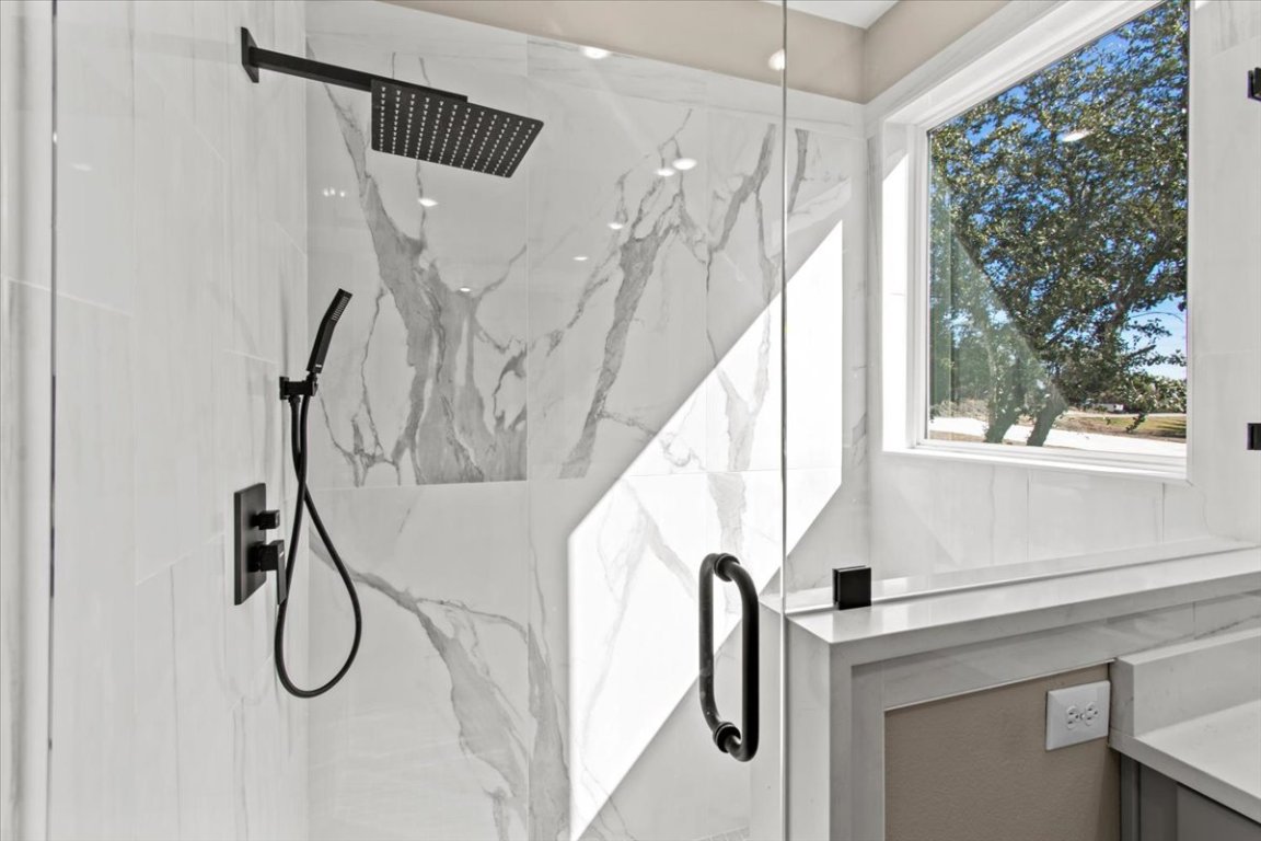 17503 Panorama Drive Dripping Springs, TX 78620 - Photo 13 of 26 a bathroom with a shower and a window