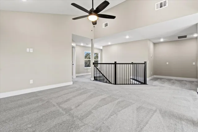 an entryway with a ceiling fan and a projector