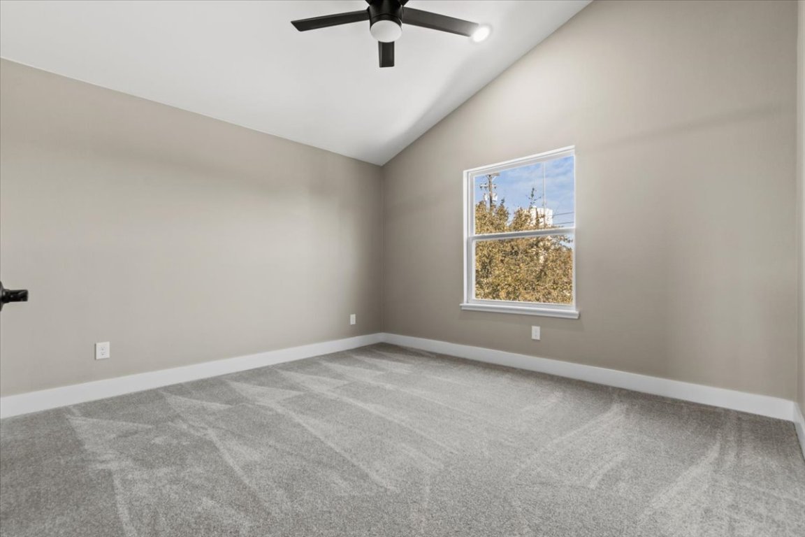 17503 Panorama Drive Dripping Springs, TX 78620 - Photo 18 of 26 an empty room with ceiling fan and window