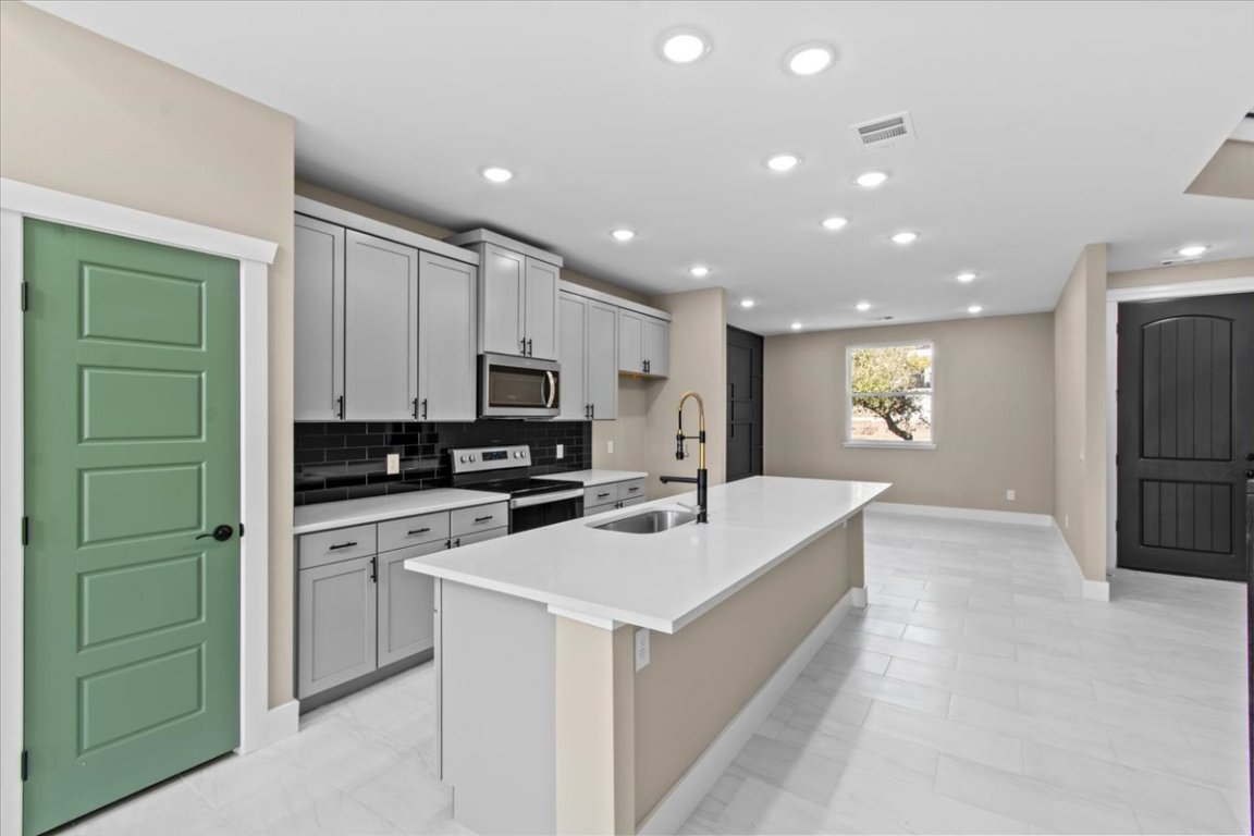 17503 Panorama Drive Dripping Springs, TX 78620 - Photo 2 of 26 a kitchen with cabinets a sink and appliances