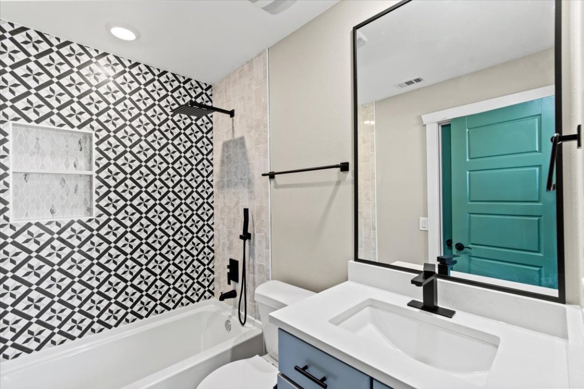 17503 Panorama Drive Dripping Springs, TX 78620 - Photo 21 of 26 a bathroom with a sink a toilet and shower