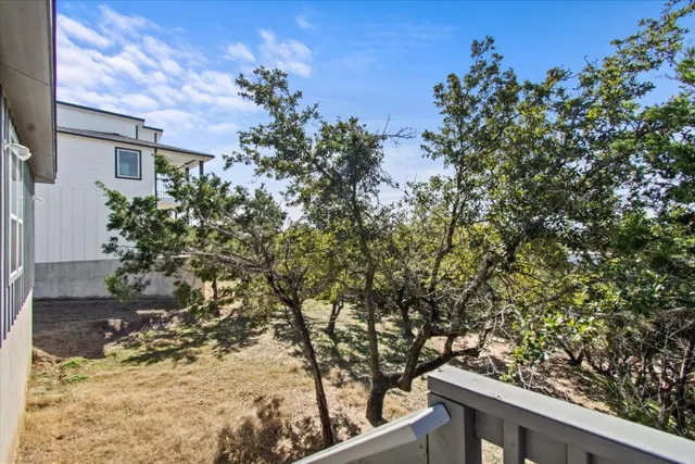 a view of a tree with wooden fence