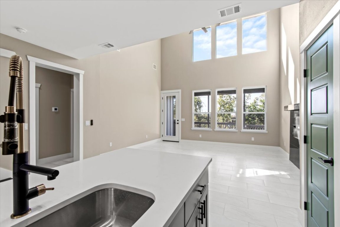 17503 Panorama Drive Dripping Springs, TX 78620 - Photo 6 of 26 a view of a kitchen with a sink dishwasher and a refrigerator