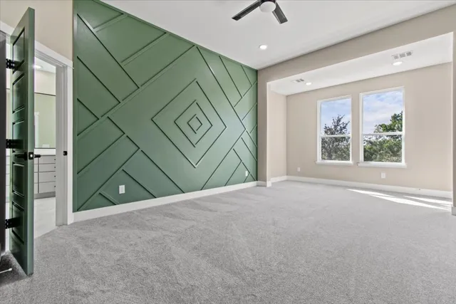 a view of a room with a window and a ceiling fan