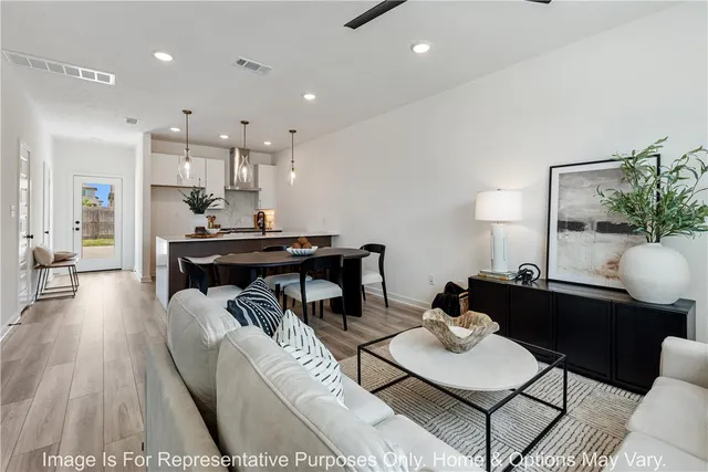 a living room with furniture and wooden floor