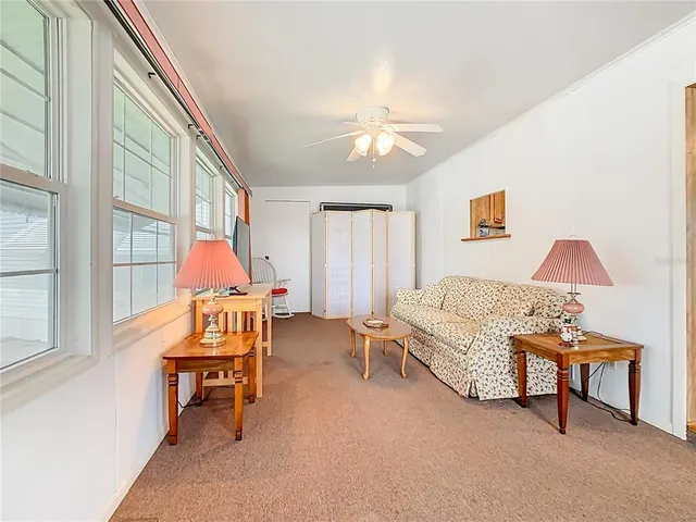 a living room with furniture a fireplace and a window