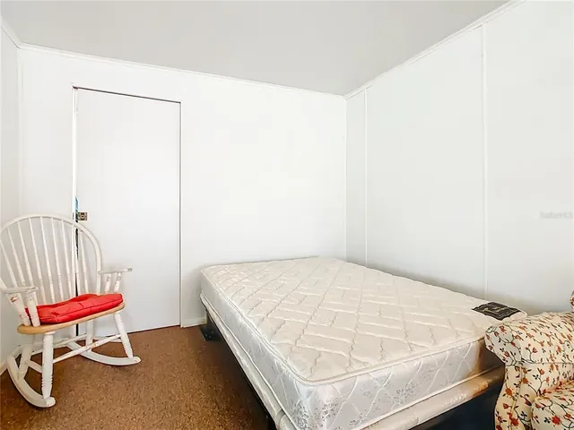 a bedroom with a bed and a chair