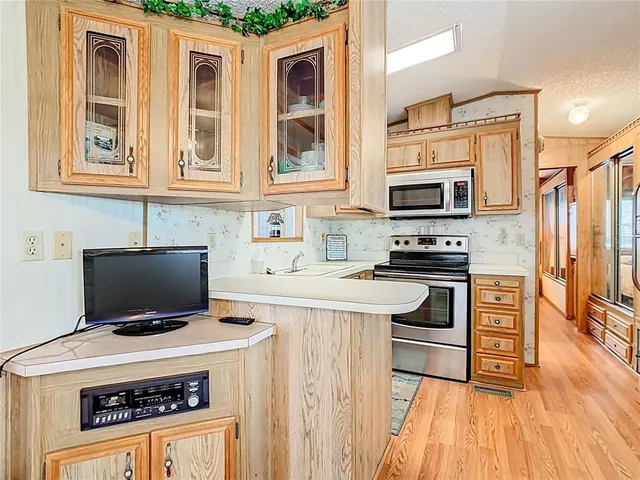 a kitchen with a stove a sink and a refrigerator