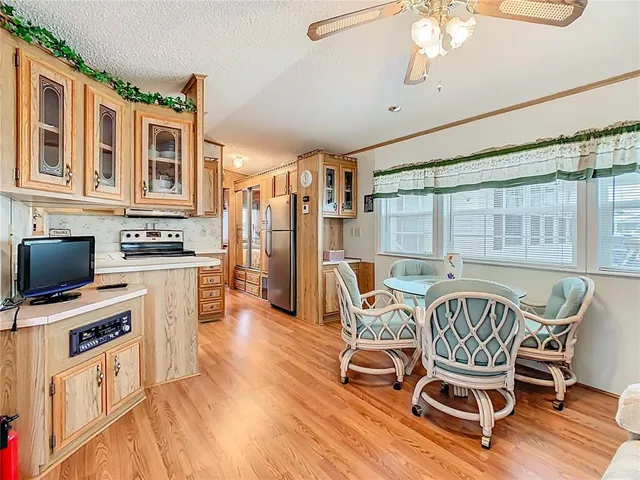 a view of a dining room with furniture a chandelier and wooden floor