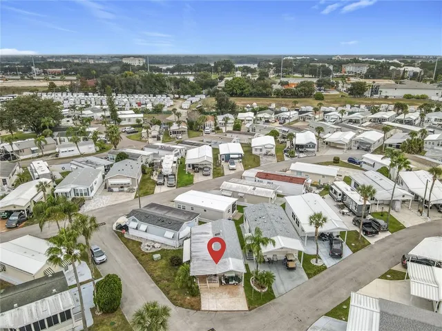 an aerial view of residential house with parking