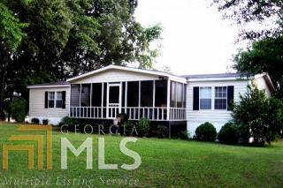 110 Glenn Road Carlton, GA 30627 - Photo 1 of 1 a front view of a house with a yard table and chairs