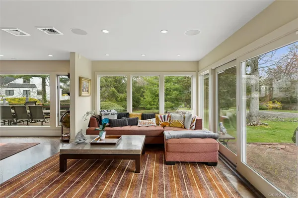 a living room with furniture and a floor to ceiling window