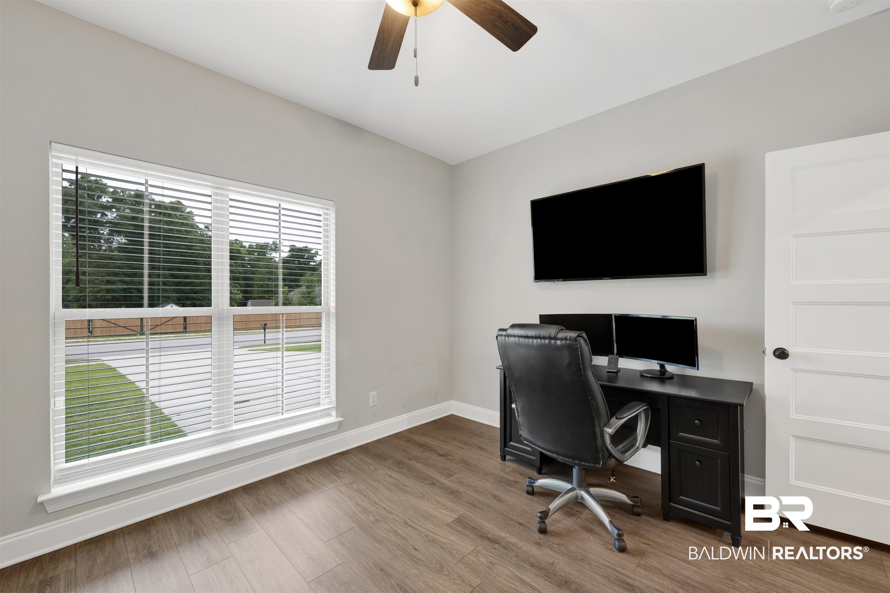 12672 Squirrel Drive Daphne, AL 36527 - Photo 29 of 49 Spacious room featuring wood-finish flooring, light gray walls, and white trim