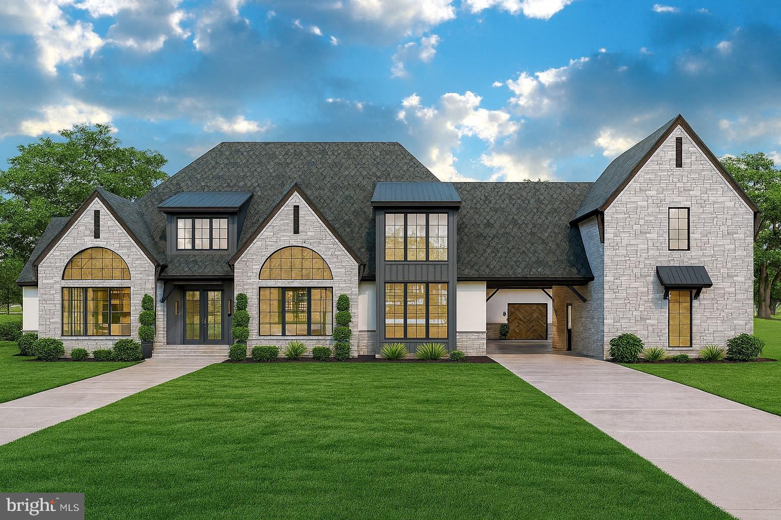 a front view of a house with a garden and yard