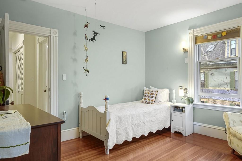 87 Hillside Road Newton, MA 02461 - Photo 18 of 30 a bedroom with a bed and wooden floor