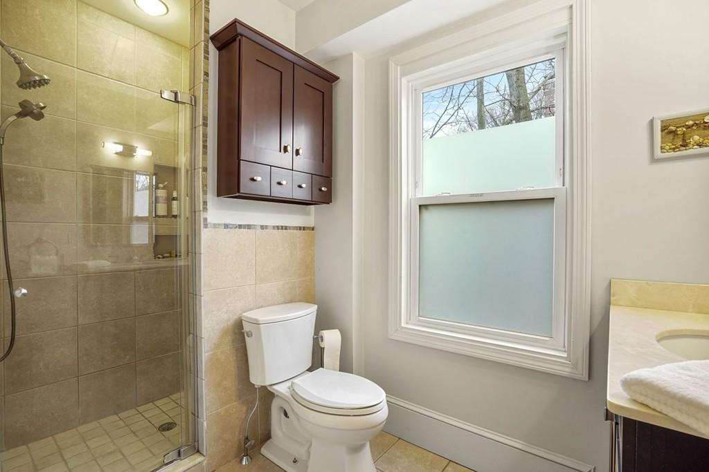 87 Hillside Road Newton, MA 02461 - Photo 19 of 30 a bathroom with a toilet sink and shower