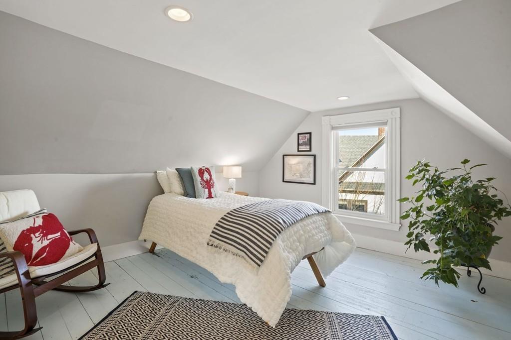 87 Hillside Road Newton, MA 02461 - Photo 20 of 30 a bedroom with a bed and a potted plant