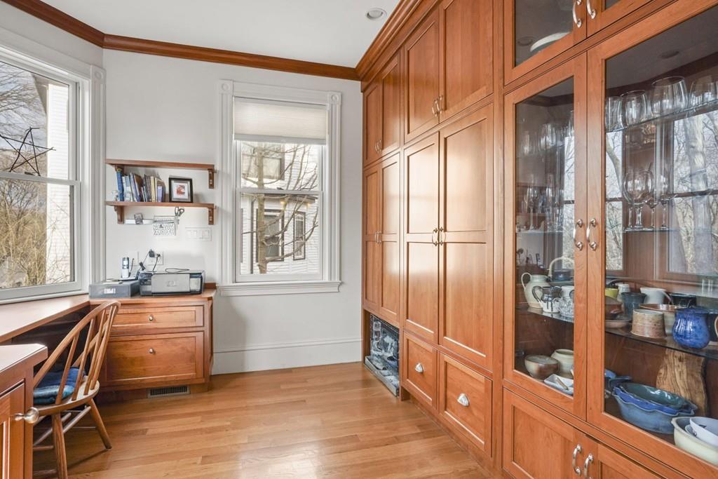 87 Hillside Road Newton, MA 02461 - Photo 7 of 30 a kitchen with granite countertop a refrigerator and wooden cabinets