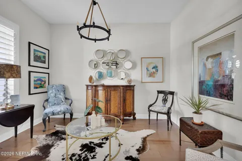 a living room with furniture a dining table and a window