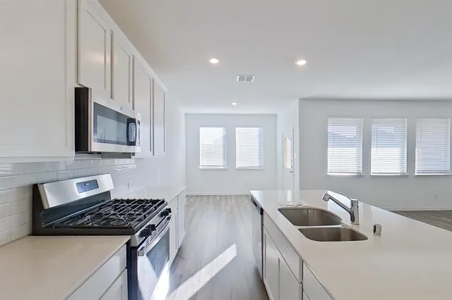 a kitchen that has a sink and a stove