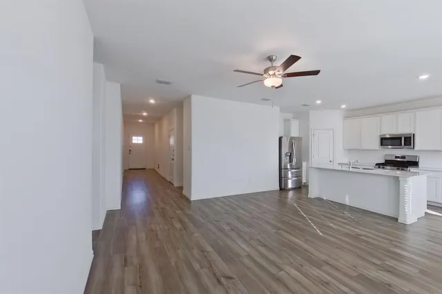 a view of a kitchen with a sink and a refrigerator