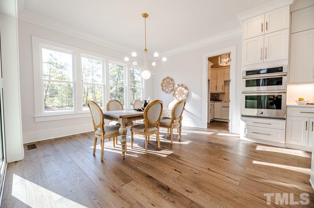 1501 Kirkby Lane Raleigh, NC 27614 - Photo 17 of 54 a view of a dining room with furniture window and wooden floor
