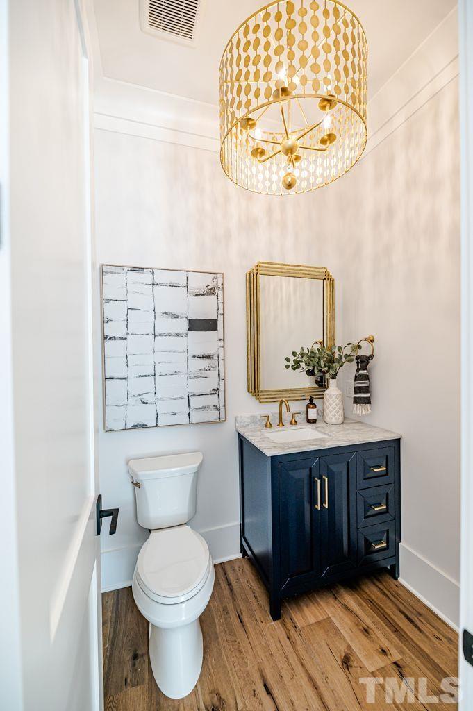 1501 Kirkby Lane Raleigh, NC 27614 - Photo 27 of 54 a bathroom with a sink vanity mirror and toilet