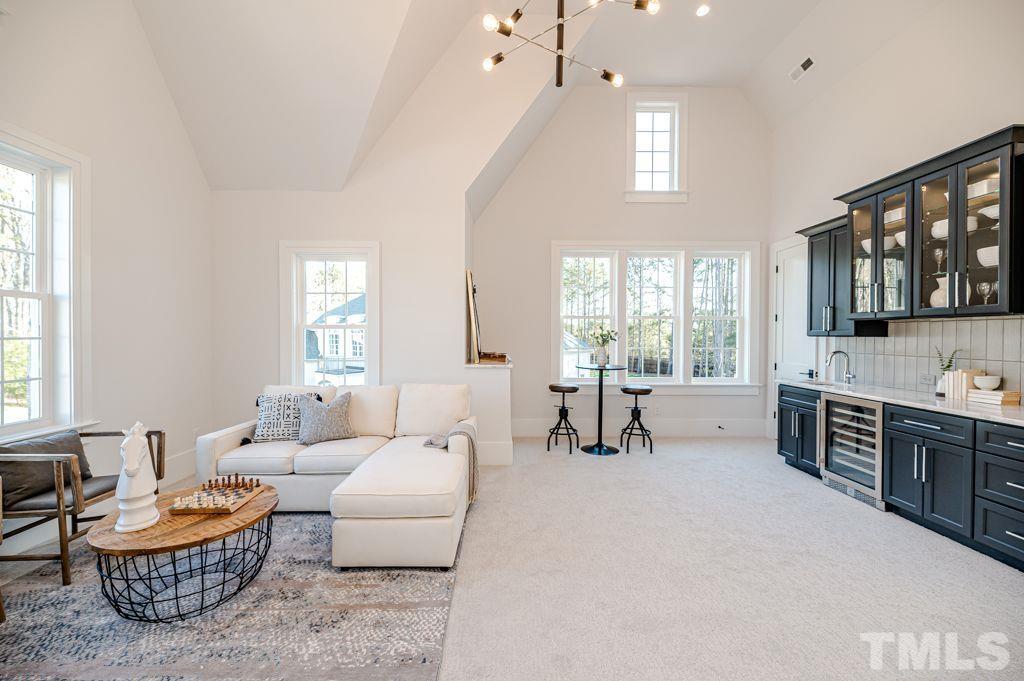 1501 Kirkby Lane Raleigh, NC 27614 - Photo 40 of 54 a living room with furniture a large window and a fireplace