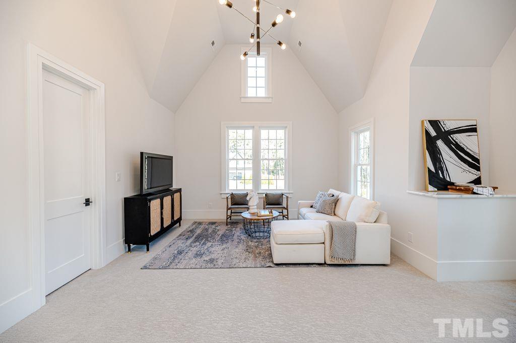 1501 Kirkby Lane Raleigh, NC 27614 - Photo 41 of 54 a living room with furniture a flat screen tv and a window