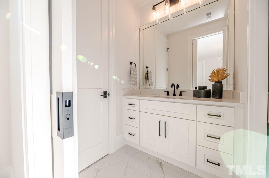 1501 Kirkby Lane Raleigh, NC 27614 - Photo 45 of 54 a bathroom with a double vanity sink and mirror