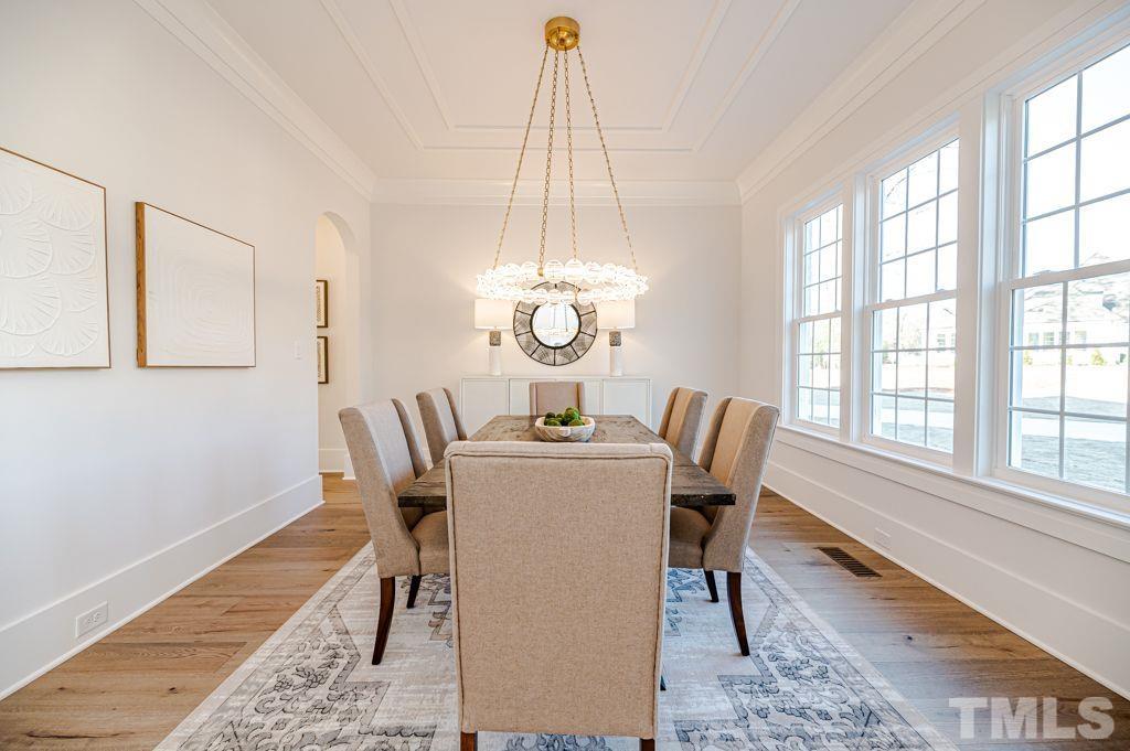 1501 Kirkby Lane Raleigh, NC 27614 - Photo 7 of 54 a dining room with furniture a chandelier and wooden floor
