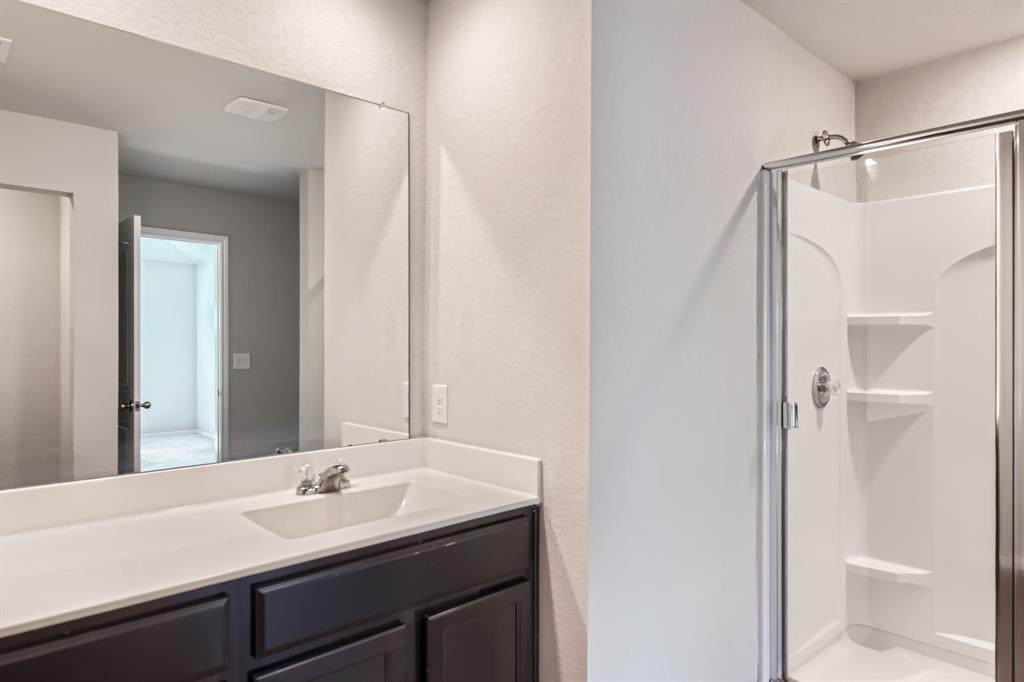 6417 Wideleaf Drive Austin, TX 78724 - Photo 15 of 27 a bathroom with a sink and a mirror