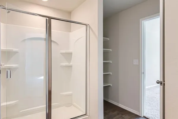 a bathroom with a glass shower door