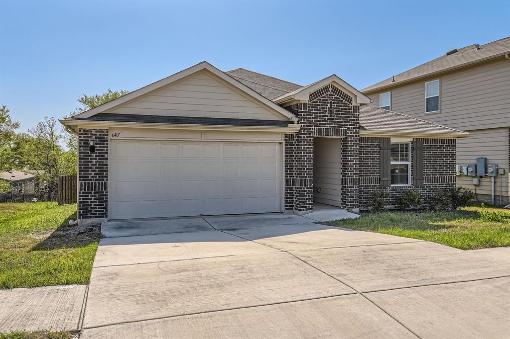 6417 Wideleaf Drive Austin, TX 78724 - Photo 2 of 27 a front view of a house with a yard and garage