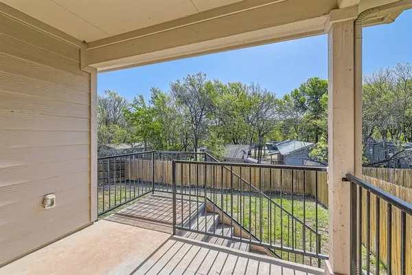 a view of a balcony with wooden floor