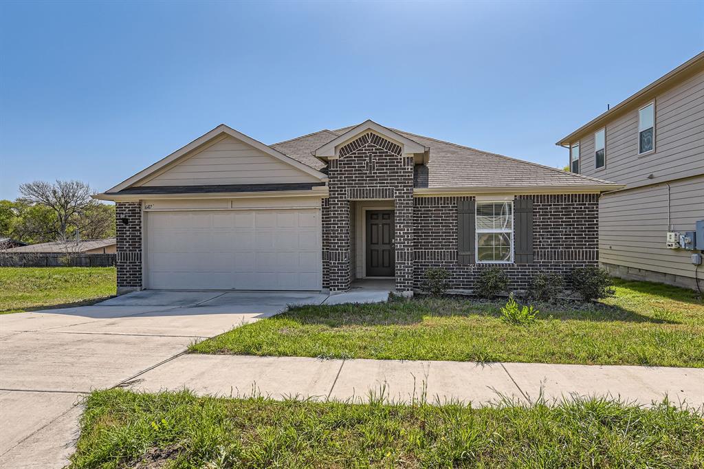 6417 Wideleaf Drive Austin, TX 78724 - Photo 3 of 27 a front view of a house with a yard and garage
