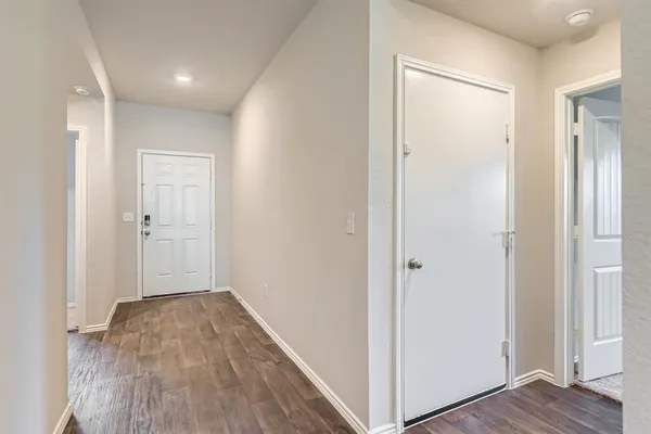a view of hallway with wooden floor
